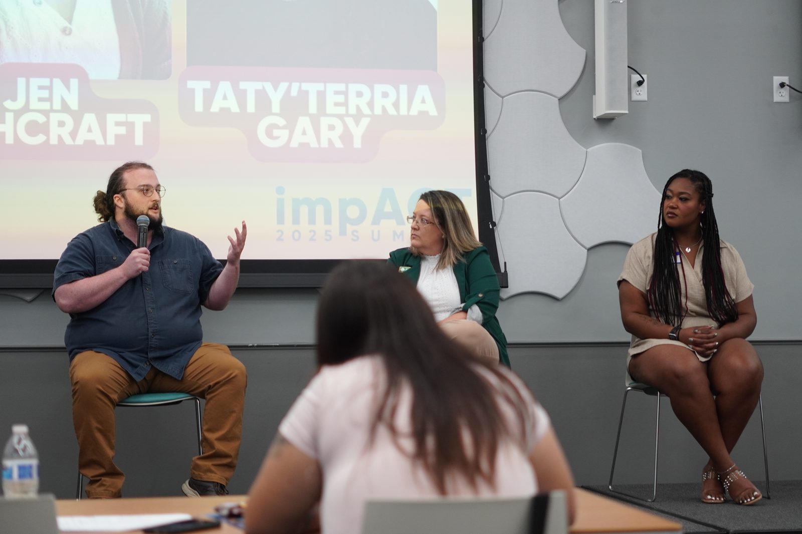 Panelists speaking at the ImpACT Summit
